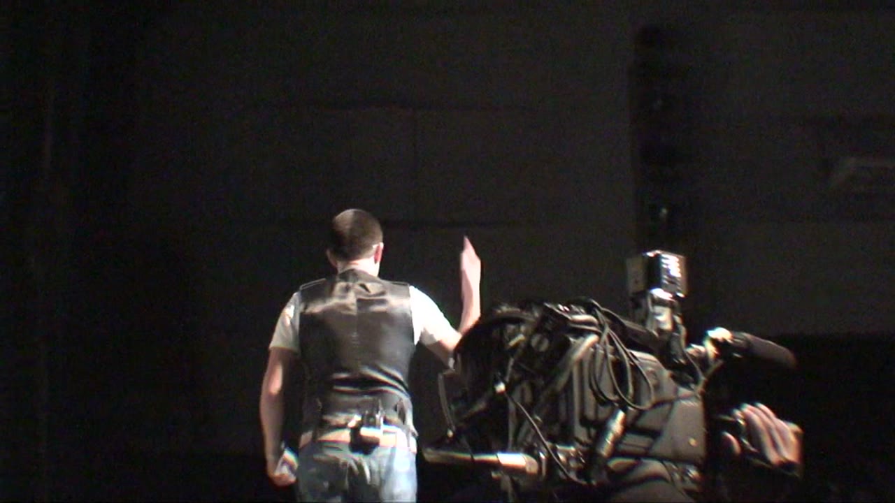 Un camarógrafo prepara la cámara antes de una conferencia, 2010